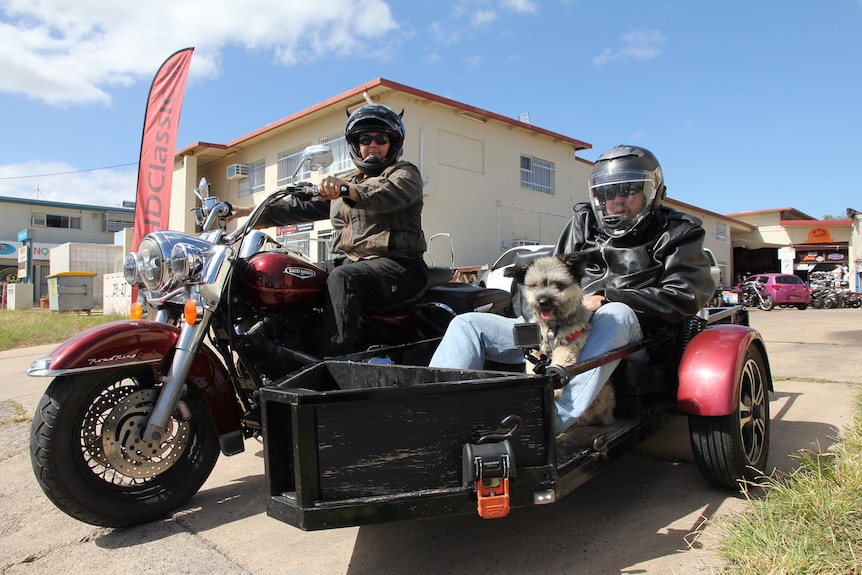 Mechanic Sharine Milne on a motorbike with a man in her sidecar.