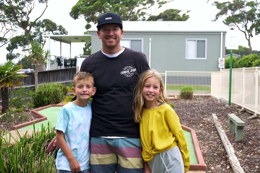 Dan Rowland on holidays in Ulladulla playing mini golf with his two children, a boy and a girl about 6 to 10 years of age.