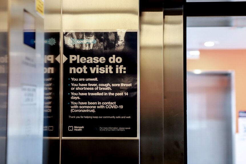 Sign inside a silver elevator asking a series of questions relating to COVID-19