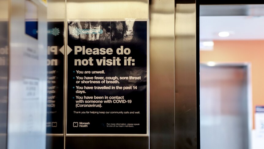 Sign inside a silver elevator asking a series of questions relating to COVID-19