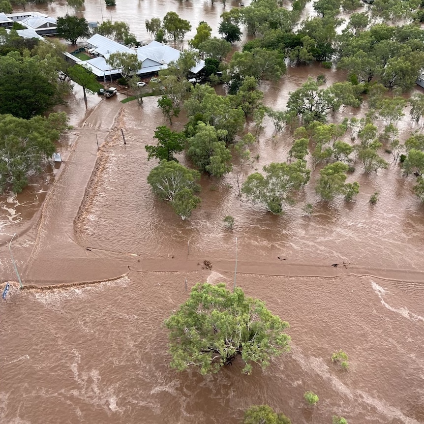 An aerial shot of the Fitzroy Crossing Bridge flooded by record water levels.