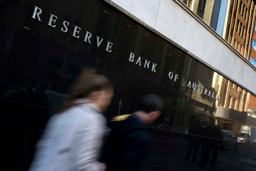 People walk past the Reserve Bank of Australia