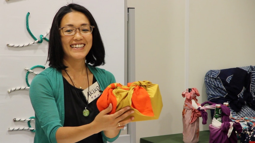 Japanese woman holds box wrapped in fabric