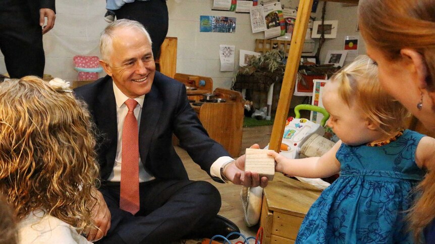 Prime Minister Malcolm Turnbull plays with blocks and maths toys with children