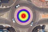A rainbow-coloured roundabout.