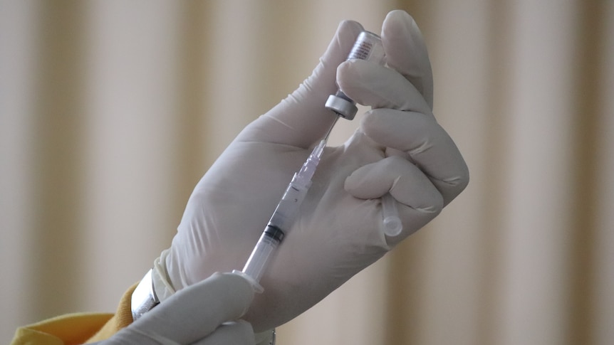 Health worker preparing vaccination injection 