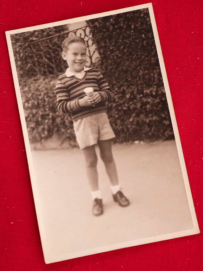 A photograph of a black and white photo of a boy in shorts
