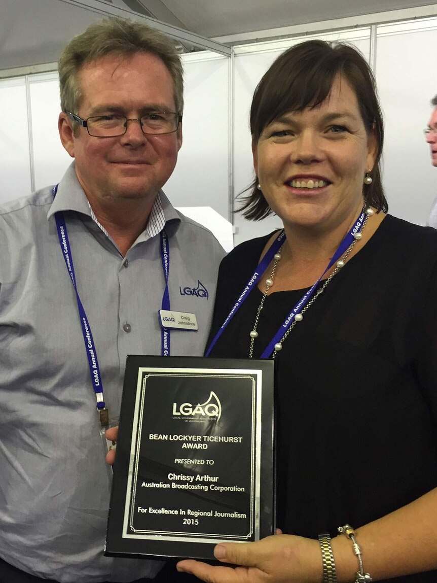 ABC journalist Chrissy Arthur, with LGAQ media executive Craig Johnstone, with her award for journalistic excellence