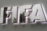 Raindrops flow down on a logo in front of FIFA's headquarters in Switzerland on June 8, 2016.
