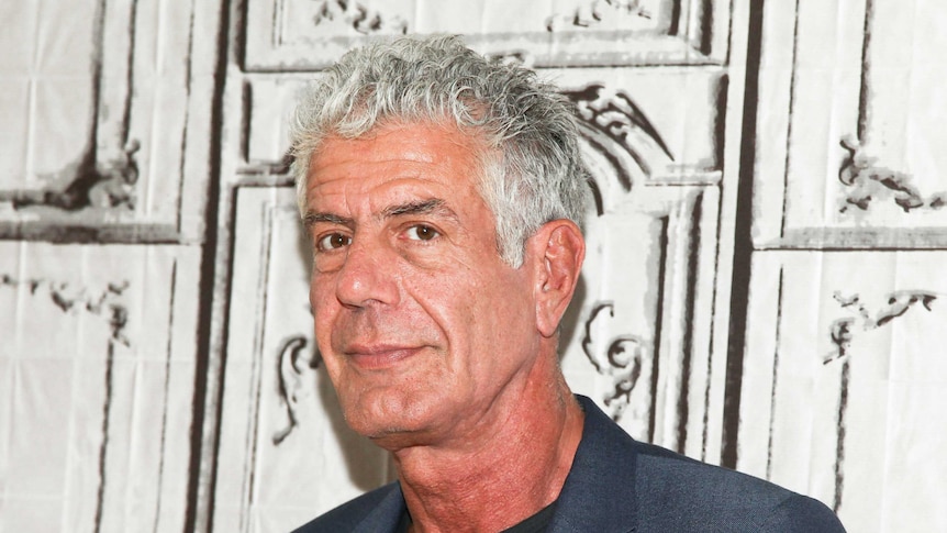 Anthony Bourdain is seen posing for a photo.
