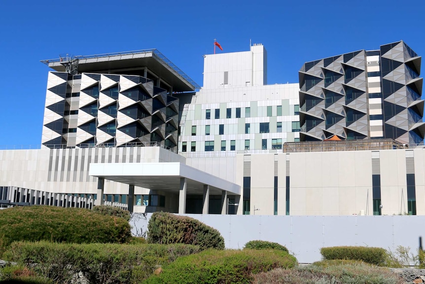 A wide shot of the exterior of the Fiona Stanley Hospital exterior.