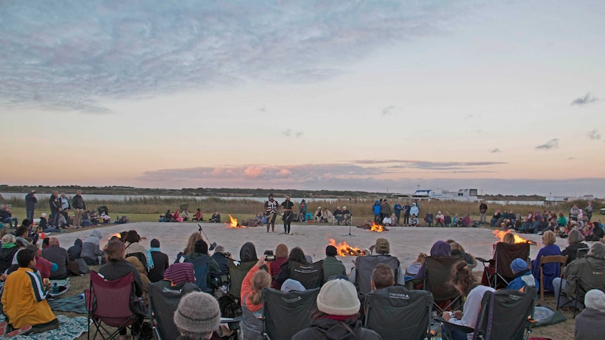 Crowd watches Ngarrindjeri songs at Goolwa as the sun sets.