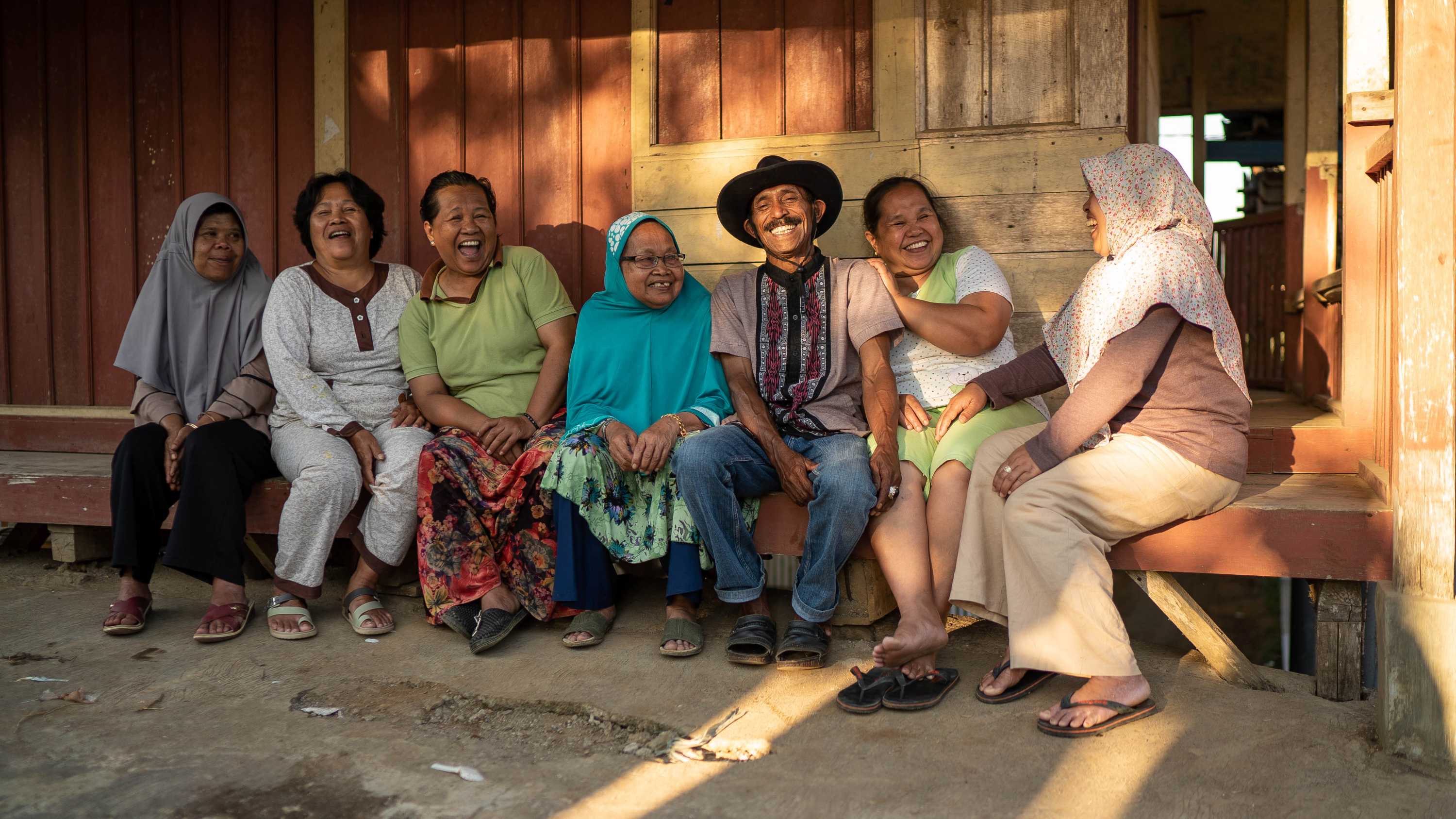 Alis and his sisters and mother laughing.