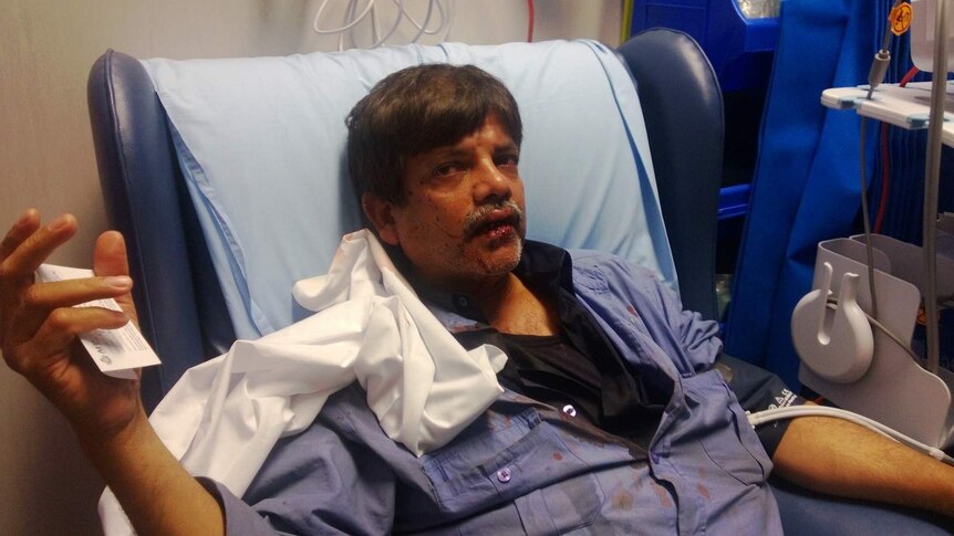 Mohammad Hussain says he was punched several times, leaving him with missing teeth and a blood-stained uniform.