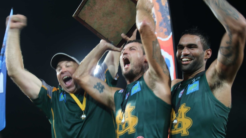 St Mary's captain Peter MacFarlane holds aloft the premiership cup after a tough victory.