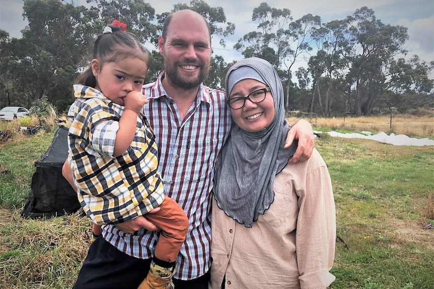 Joseph Hartley, with daughter Keisha and wife Hawa at their Tasmanian rice crop, February 2020.