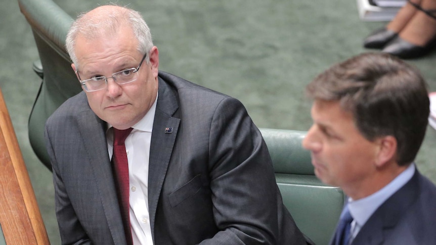 Angus Taylor speaks at the despatch box with Scott Morrison sitting behind him