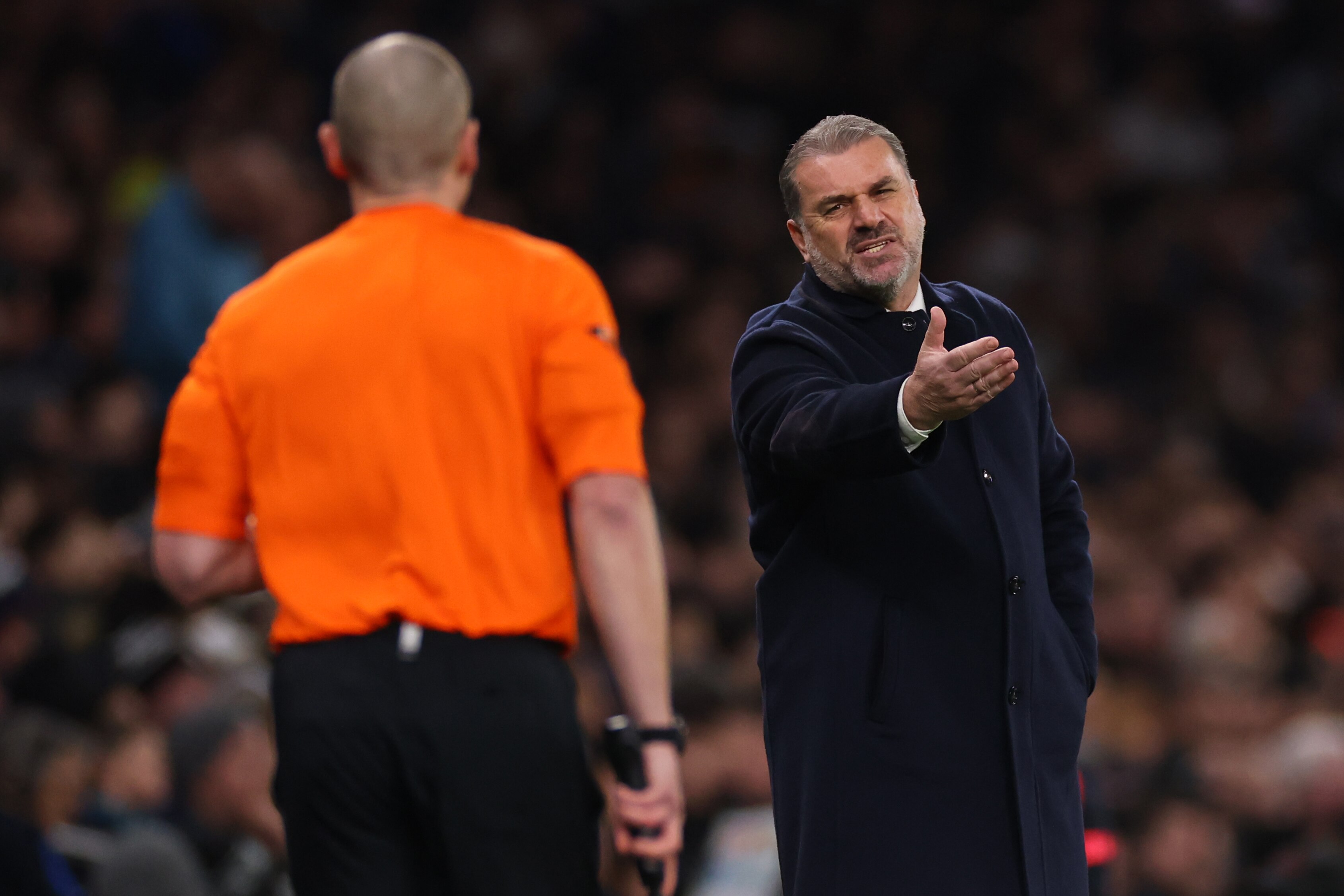 Ange Postecolgou talks to the assistant referee
