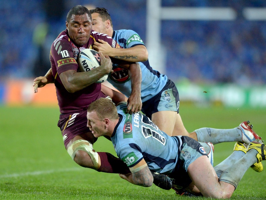 Luke Lewis and Anthony Watmough bring down Petero Civoniceva.