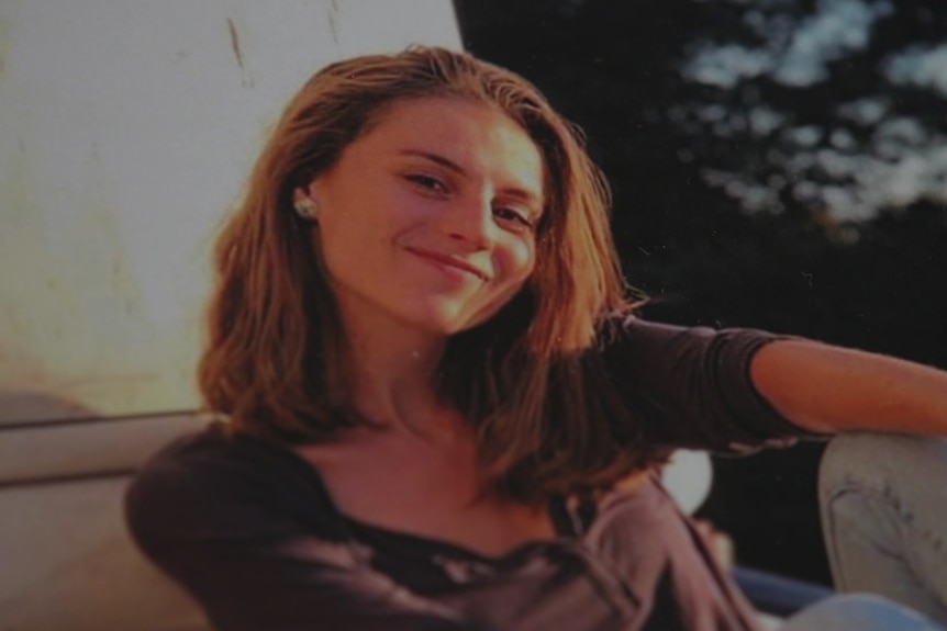 A young woman smiles while posing for a photo.