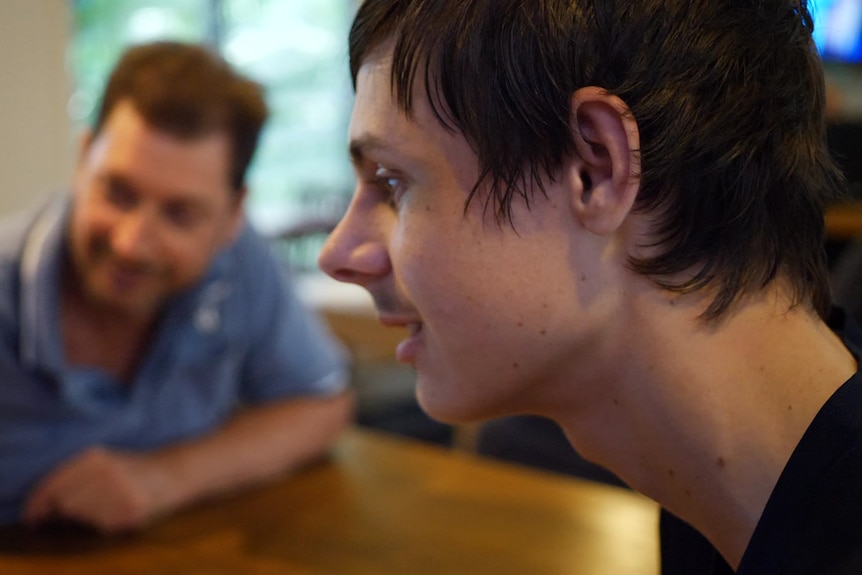 Jonty Beard sits at a table.