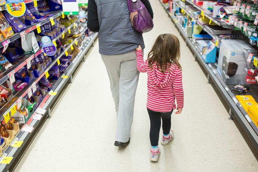 Jayde walks beside Sue in a supermarket.