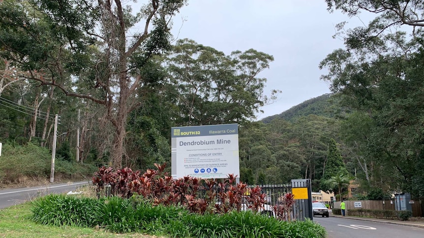 A sign and the road outside the Dendrobium mine