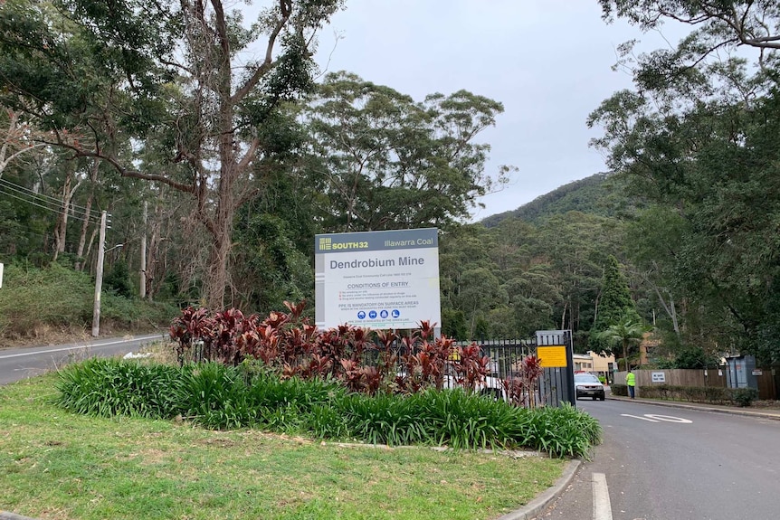 A sign and the road outside the Dendrobium mine