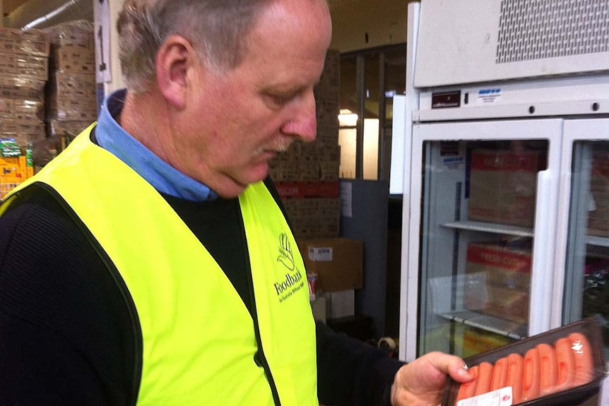 Ed Gauden from the charity Foodbank inspects donations.