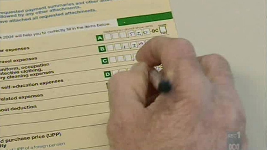 Close up of hand writing income information on to ATO tax pack. In 2012 the ATO dumped its paper based Tax Pack and encouraged people to lodge their tax returns online. Taken: 2009