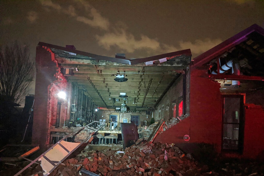 Scattered bricks and what reminds of a building after the tornado.