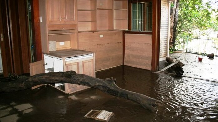 Floodwaters wash debris into home