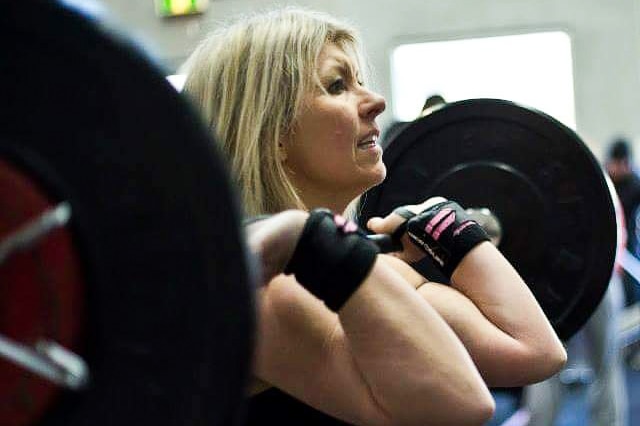 A shot from the gym of Deni Cameron performing a dead lift.