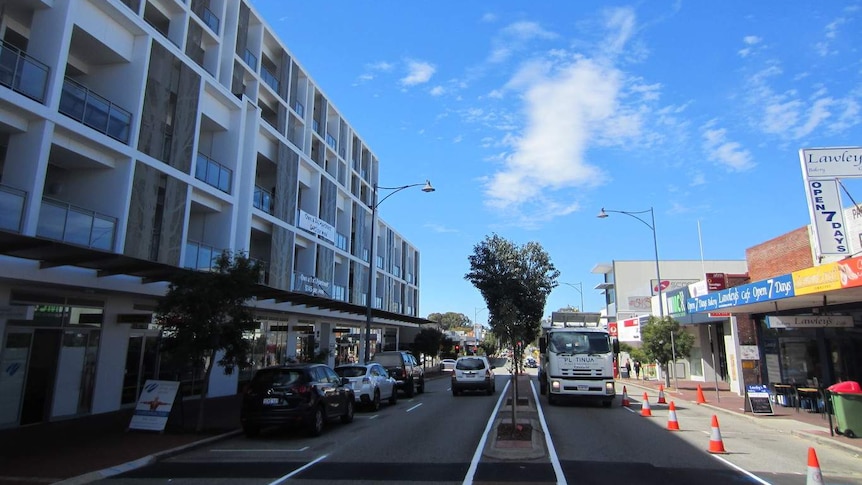 High-rise apartments line a street in suburban Perth