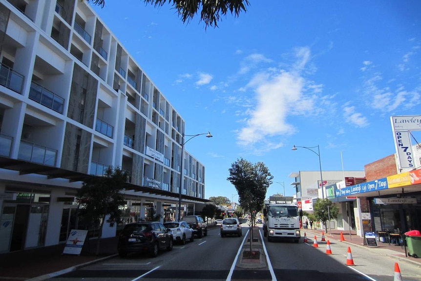 High-rise apartments line a street in suburban Perth's.