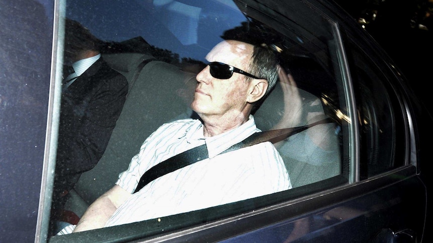 Robert Hughes arrives at Surry Hills police station in Sydney after being extradited from the UK.