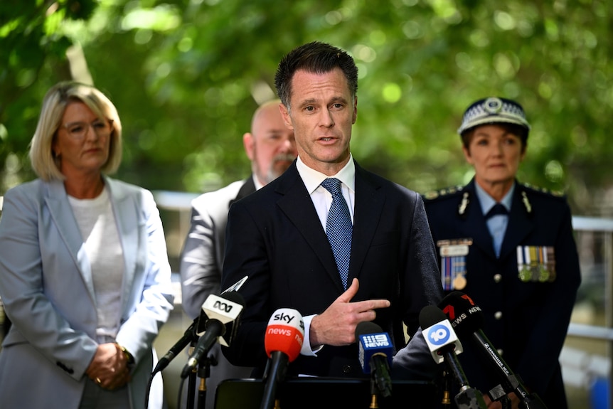 NSW Premier Chris Minns stands at press conference with Police Minister Yasmin Catley and NSW Police Commissioner Karen Webb