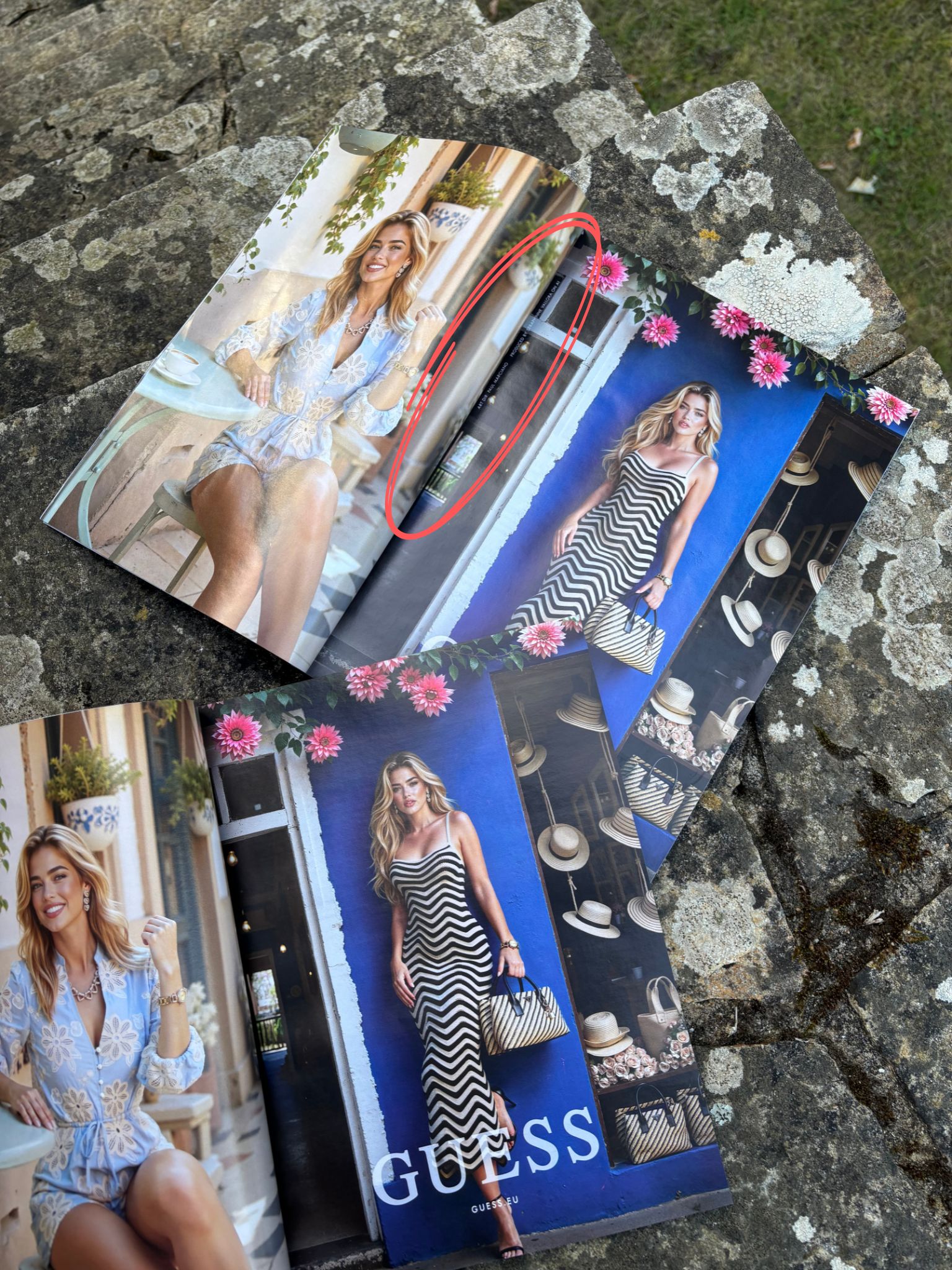 A fashion magazine spread out on a dappled stone