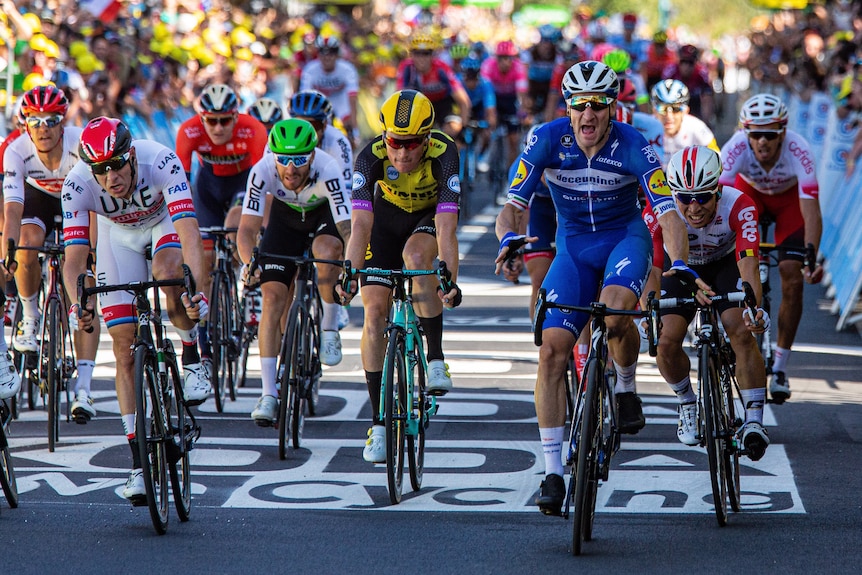 A peloton of cyclists dash for the finish line at the Tour de France