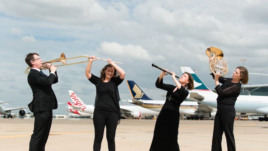 Musicians on the tarmac in Brisbane.