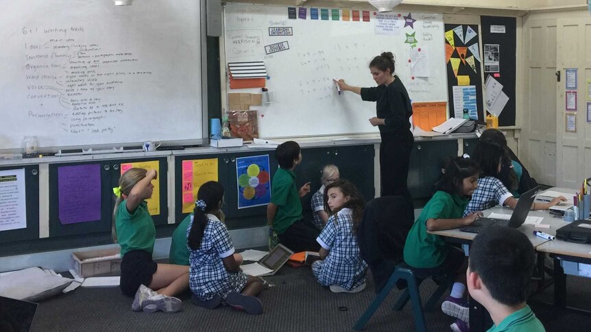 Bethany Corrigan pointing to a whiteboard as she teaches her class