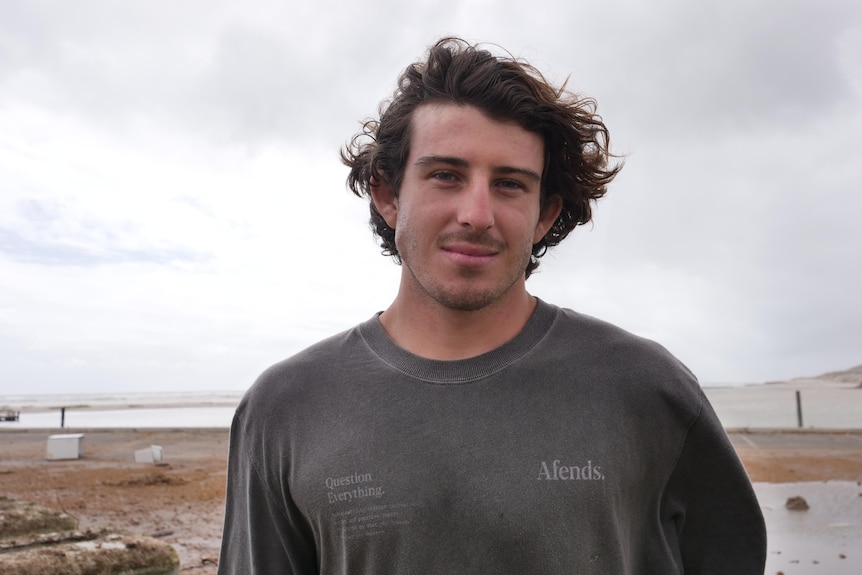 Dylan Stevenson stands outside in windy conditions.