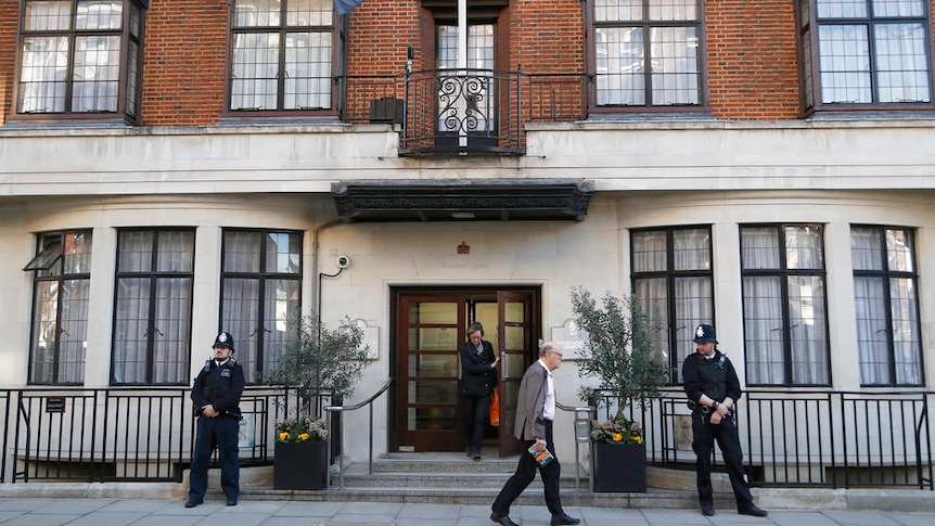 Police officers guard the entrance of King Edward VII Hospital in London.