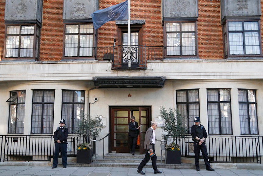 Police officers guard the entrance of King Edward VII Hospital in London.