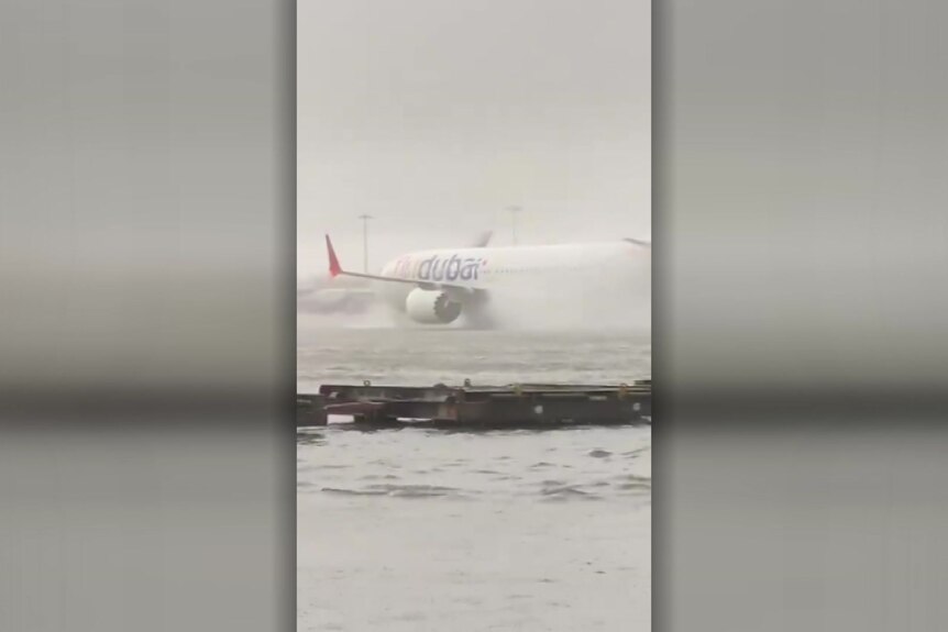 Mobile vision shows an airliner stranded on a flooded runway.