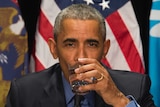 Barack Obama drinks filtered water in Flint.