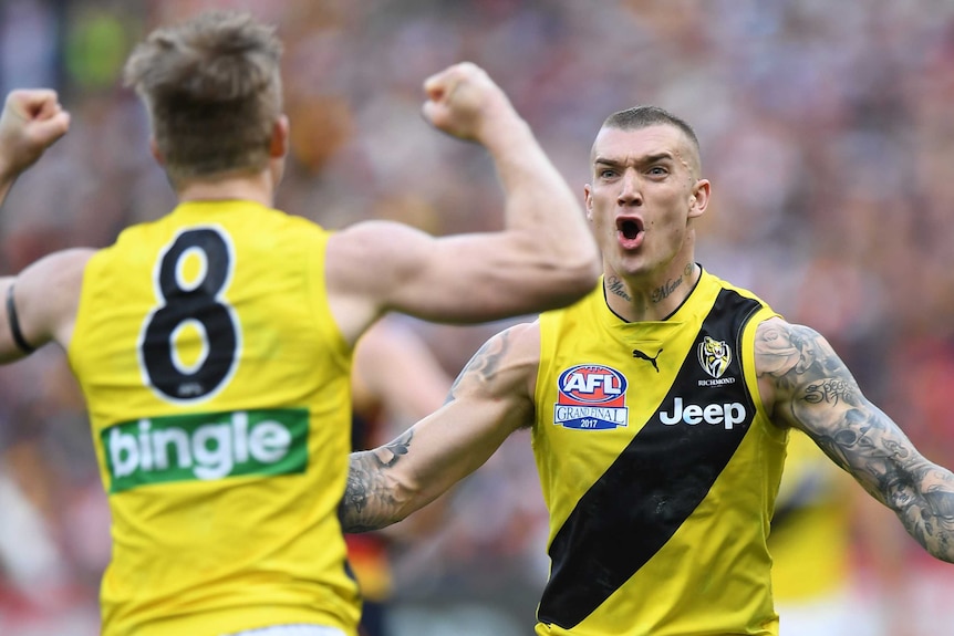 Dustin Martin and Jack Riewoldt cheer after a goal is kicked.