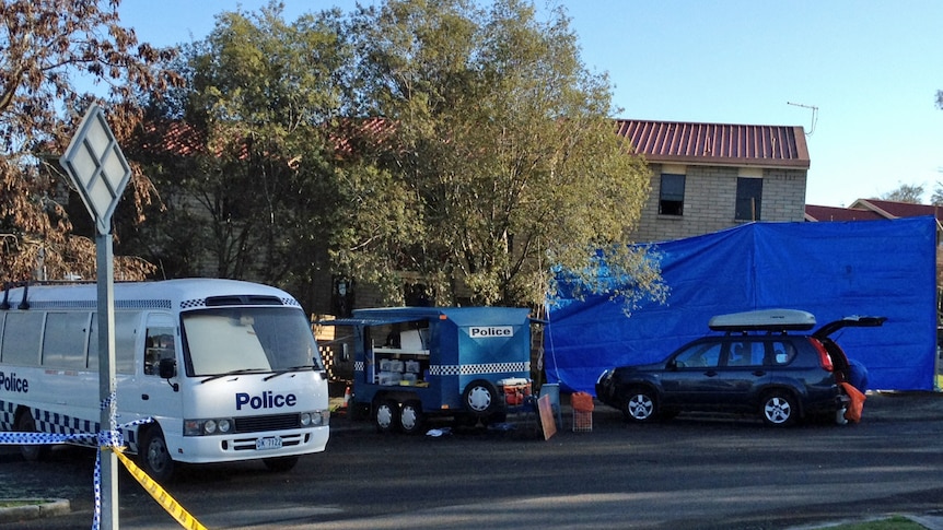 Police outside a unit in Ravenswood, Tasmania, where two bodies were found.