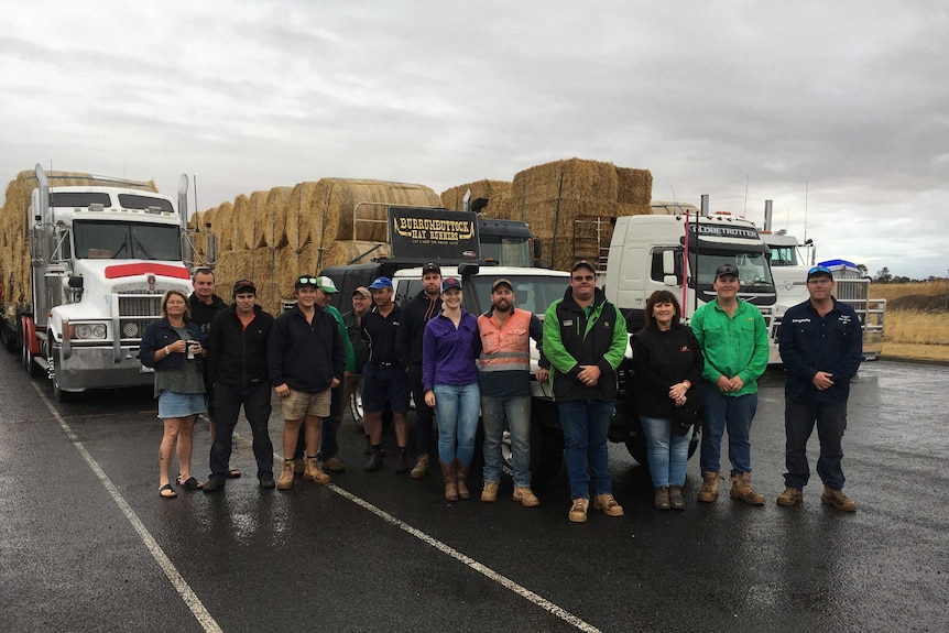 A group of farmers at the Horsham Regional Livestock Exchange preparing to take hay to New South Wales.