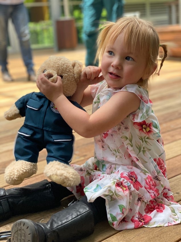 Saphira Harwood holds a teddy bear.